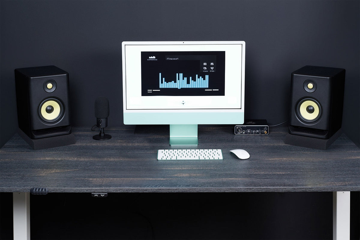 Pair of studio monitors on SMPad 5 foam isolation pads on a desk