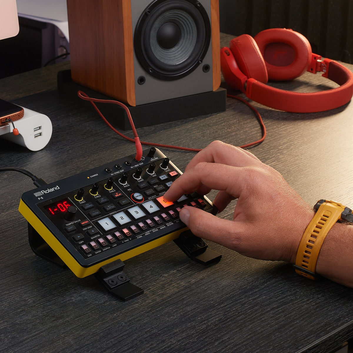 Producer playing a Roland AIRA Compact T-8 on the Sound Addicted stand
